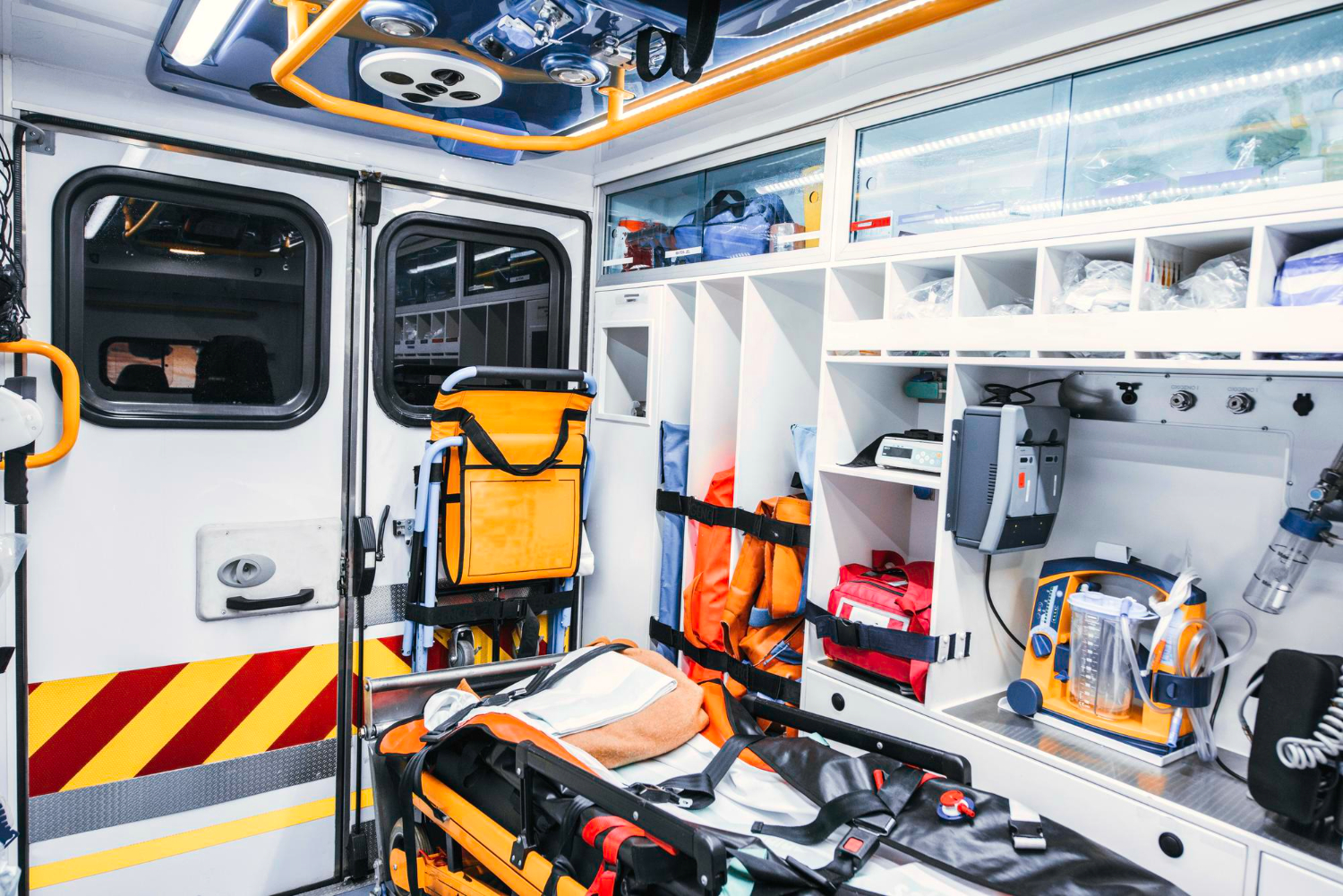 The interior of an ambulance, fully stocked with medical supplies and equipment after a complete EMS rig check.